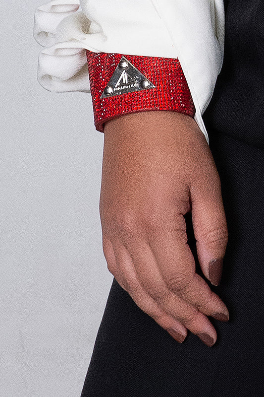 Chic red crystal bracelet featuring a shiny logo plaque, adding sophistication and style to your wrist.