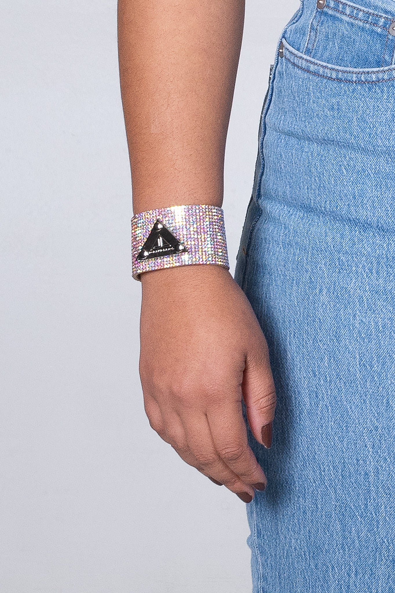 Stand out from the crowd with the eye-catching multicolor crystal-covered bracelet, featuring a polished logo plaque.