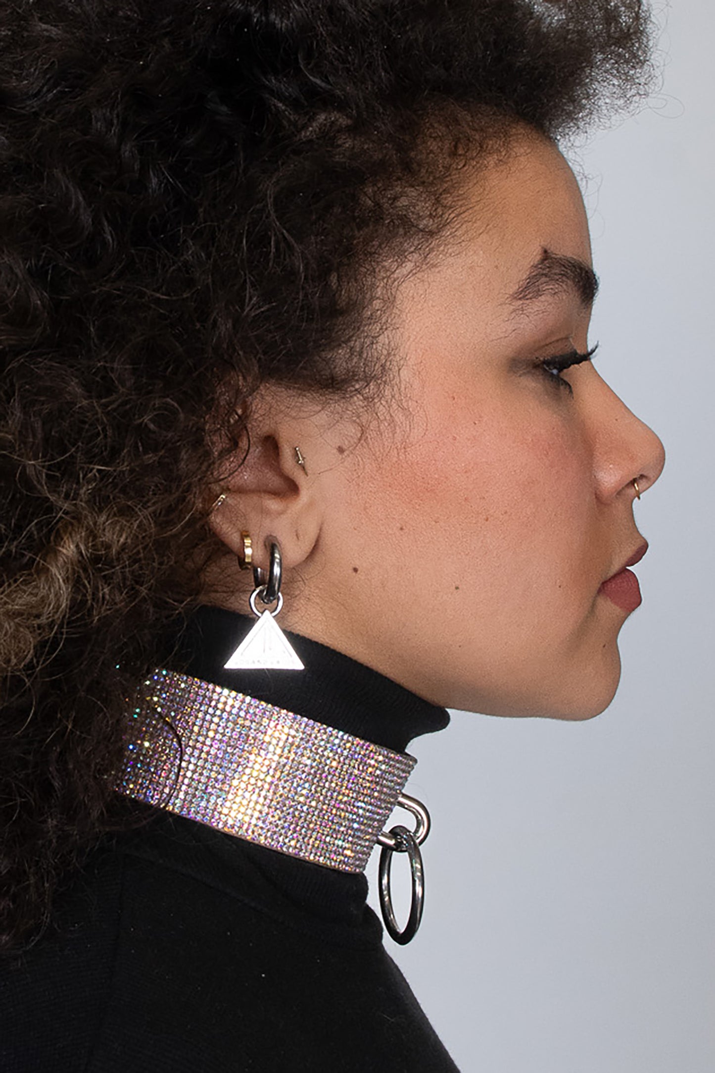 Shiny rhinestone choker featuring a sparkling surface, front ring detail, and adjustable back buckle, offered in multicolor
