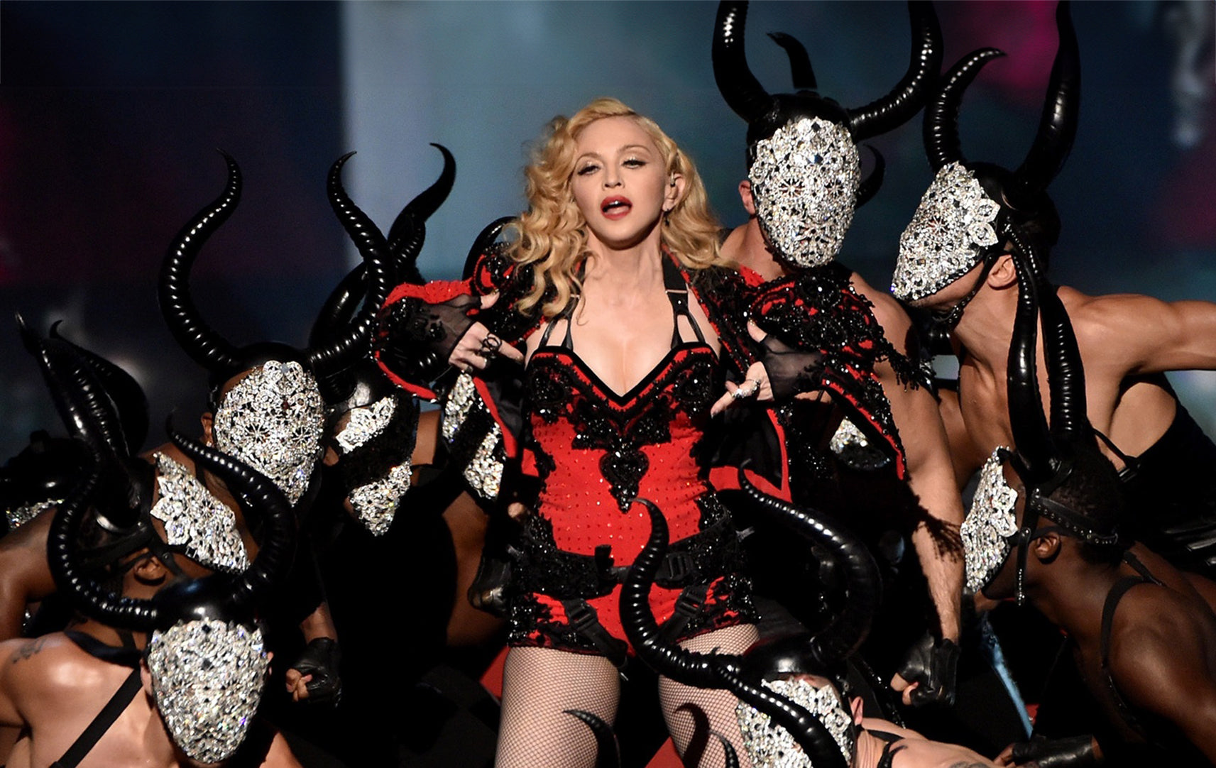 Madonna surrounded by her Minotaurs wearing Lorand Lajos´s crystal mask designs at the Grammys performance Living for Love